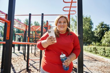 Woman engages in workout while enjoying nature in the park. clipart