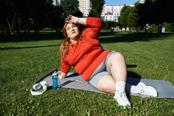 A confident woman exercises outdoors, soaking up the warmth of the sun.