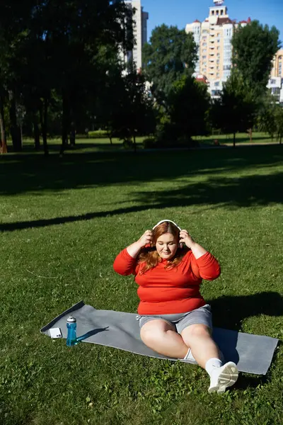 stock image A plus size woman exercises outdoors, embracing nature and fitness.