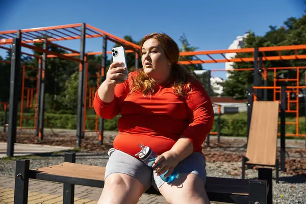 stock image A confident woman taking a break while exercising outdoors.