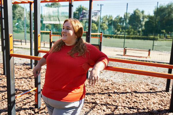 Woman embraces fitness and joy while working out in the park.