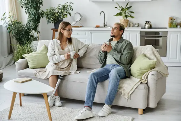 stock image A non binary person engages in lively conversation with a friend.