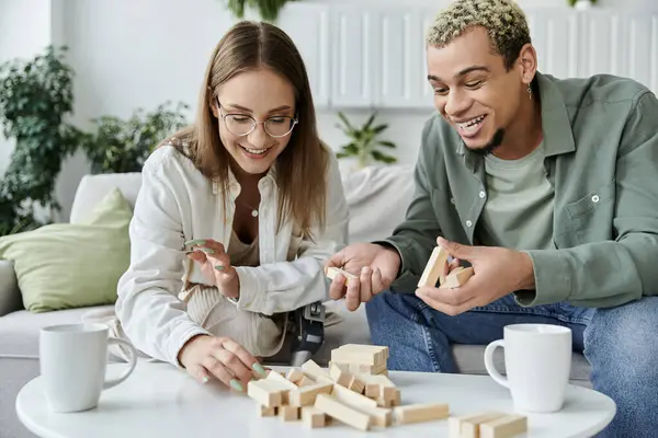 Stock image Two friends joyfully engage in a game while sharing laughter and conversation.