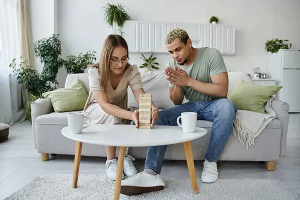 stock image Friends share laughter and excitement while playing a game at home.