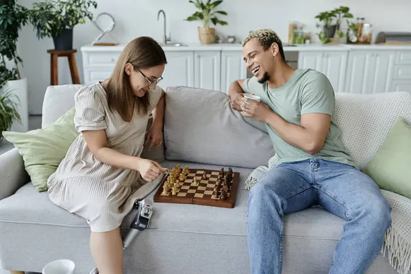 stock image Friends share laughter and strategy while playing chess in a comfy living room.