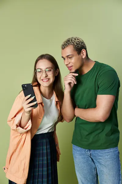 stock image Friends share a joyful moment looking at their smartphones together.