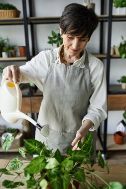 A gardener cares for her greenery while enjoying time in her studio. clipart