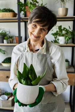 A gardener lovingly tends to her flourishing plants, showcasing her passion. clipart