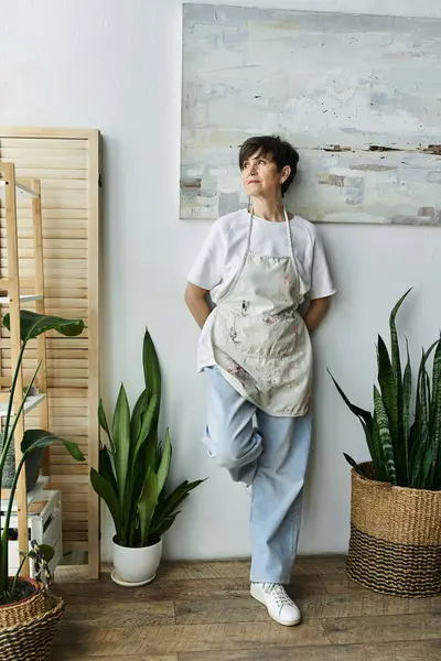 stock image A woman enjoys her creative space, lost in artistic thought.