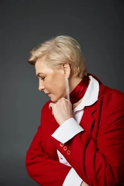 stock image A stylish woman in red and white poses gracefully, flaunting her confident profile.