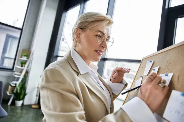 stock image A sophisticated woman shares her innovative thoughts while engaged in a collaborative workspace.