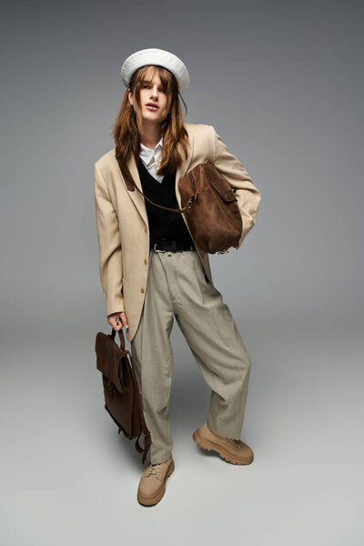 A young man showcases his trendy attire, displaying effortless style in a chic environment.