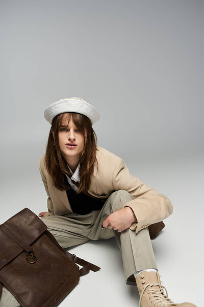 A trendy young man showcases his unique fashion sense with casual yet chic attire.