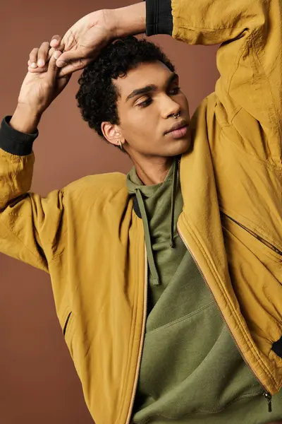 stock image A young man wears a vibrant autumn attire.