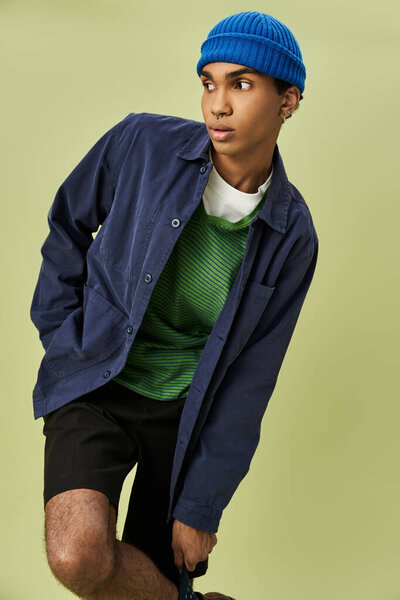 Trendy man embraces the autumn vibe with colorful outfit.