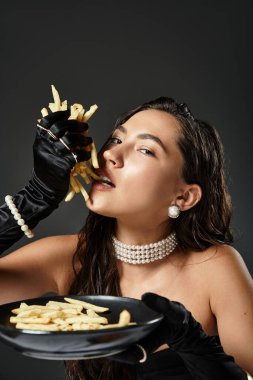 A young woman with long hair enjoys French fries, elegantly dressed with pearls and satin gloves. clipart