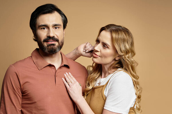 A middle aged couple shares a tender moment, conveying warmth and connection in their poses.