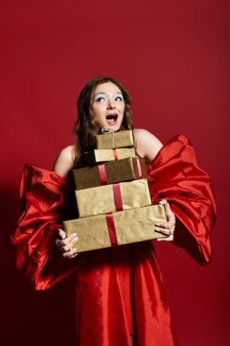 A joyful young woman in a red outfit hugs a stack of beautifully wrapped gifts. clipart