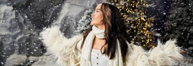 Neşeli bir insan, büyülü bir Noel ortamında süslü ağaçların arasına düşen kardan hoşlanır..