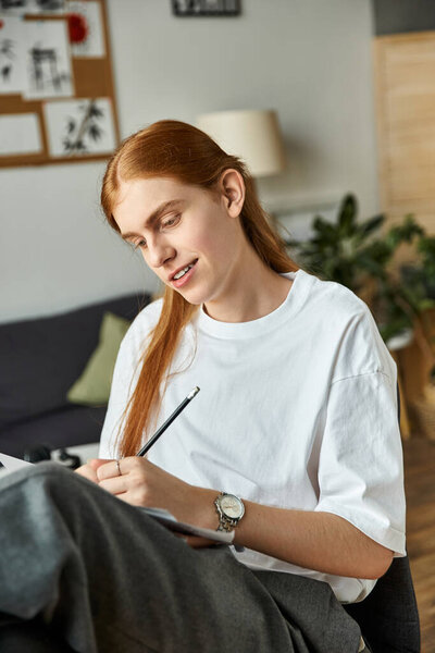A young man enjoys drawing in a relaxed atmosphere, expressing his artistic vision.