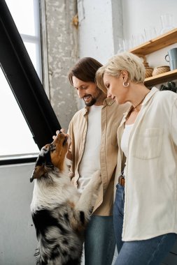 Bir çift, rahat ve davetkar bir atmosferde köpekleriyle sevgi dolu bir anı paylaşıyor..