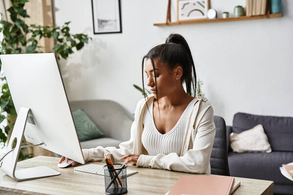 Молодая женщина занимается дистанционным обучением на своем стильном домашнем рабочем месте, демонстрируя свое внимание.