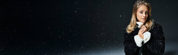 A beautiful woman wrapped in a warm coat enjoys the serene snowfall while posing elegantly.