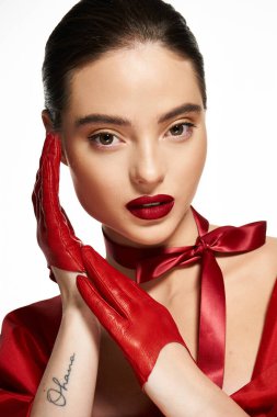 A captivating woman poses elegantly in bold red gloves and rich lipstick. clipart