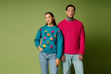 İki şık genç insan eşsiz moda anlayışlarını renkli kazaklarla ifade ederler..