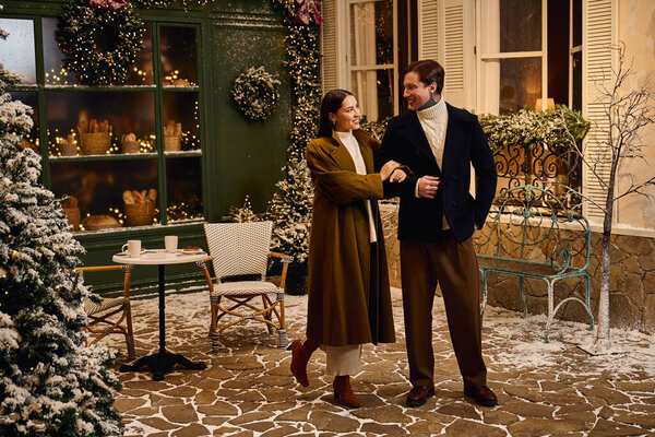 Romantic moments unfold as a couple strolls through a winter wonderland in a cozy cafe setting.