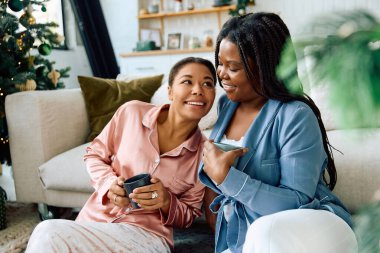 Joyful couples enjoy each others company in a cozy living space during a festive morning moment clipart