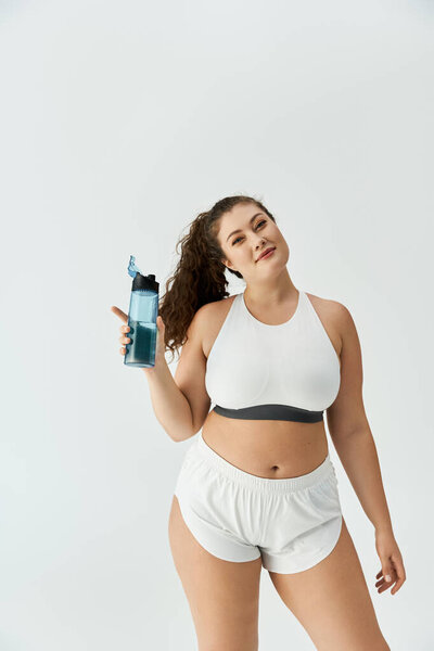 Young plus size woman showcases stylish underwear while promoting body confidence and fashion.