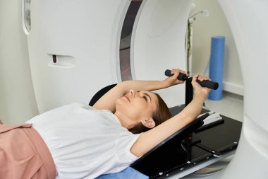 a female patient prepares for an MRI scan in a hospital setting. clipart