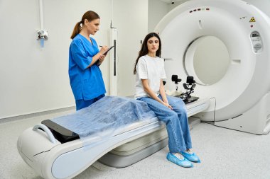 Female doctor attends to patient near MRI machine in hospital setting. clipart