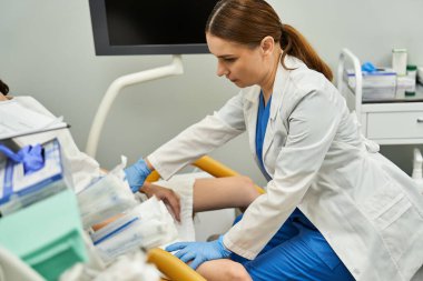 A professional gynecologist conducts a health examination with a female patient in a clinic. clipart