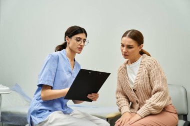 A gynecologist discusses medical findings with a female patient in a serene clinic setting. clipart