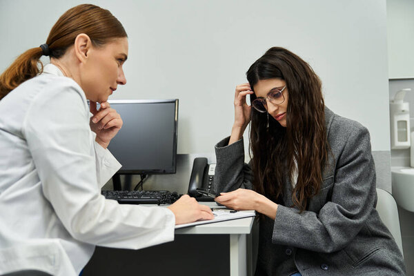 Doctor examines patients health, discussing gynecological concerns in a professional clinic