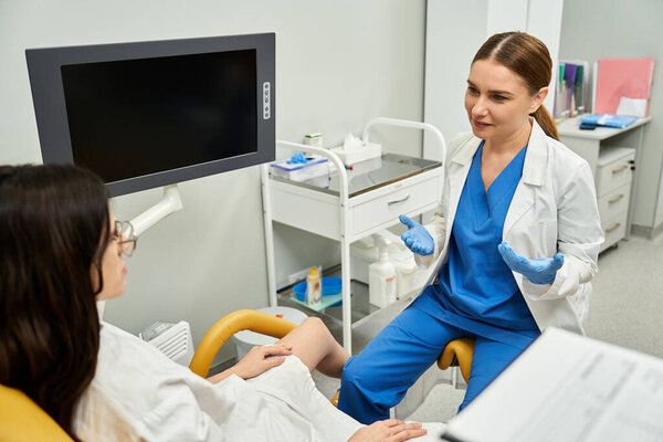 A dedicated gynecologist provides personalized care and advice to her patient in a bright clinic.