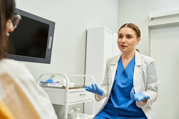 A gynecologist at a clinic provides quality health services to a female patient.