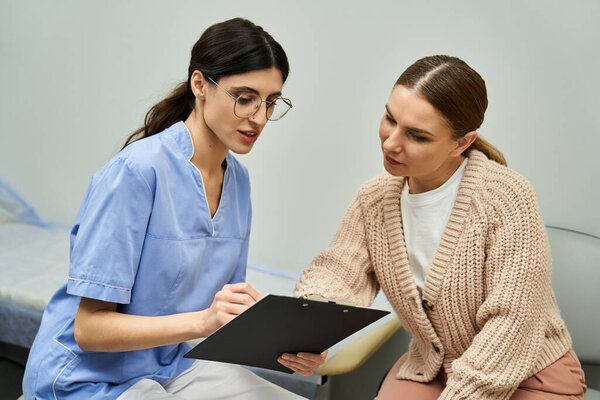 A healthcare professional discusses diagnostic results with a female patient in a clinic.