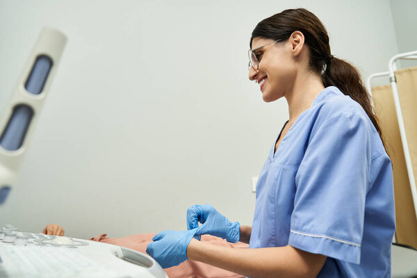 A gynecologist interacts with her patient, ensuring a comfortable checkup experience.