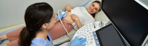 A gynecologist conducts an ultrasound examination for a female patient, focusing on health.