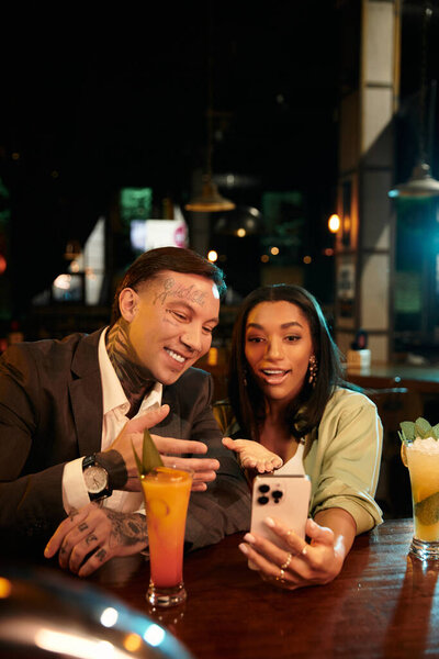 A beautiful couple shares a joyful moment while capturing memories during a date night.