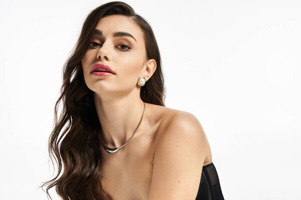 Young woman showcases her natural beauty and elegance with a confident gaze and stylish look