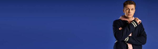 Young man stands confidently, exuding strength and style.