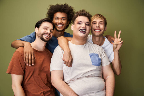 A diverse group of friends joyfully supports each other in a vibrant celebration of pride.