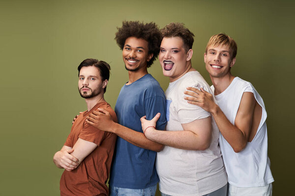 Четыре человека выражают радость и гордость, демонстрируя свои уникальные стили и товарищество вместе.