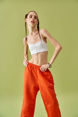 A young woman poses confidently, highlighting her struggle with anorexia and body image. clipart