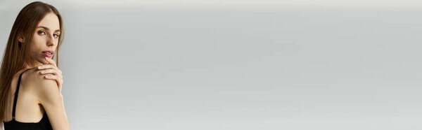 A young woman with anorexia appears contemplative in a minimalistic space, showcasing her beauty.