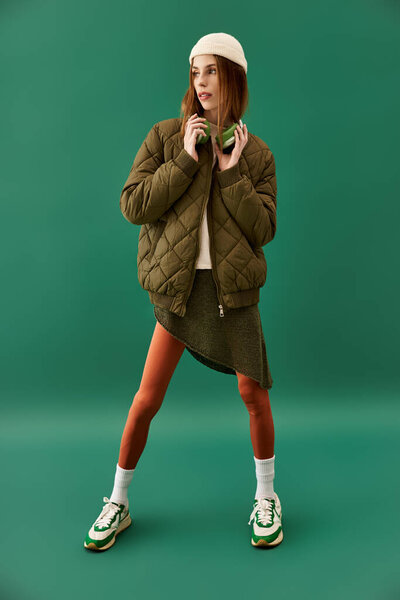 Young woman stands confidently in layered outfit, showcasing her unique fashion sense and strength.